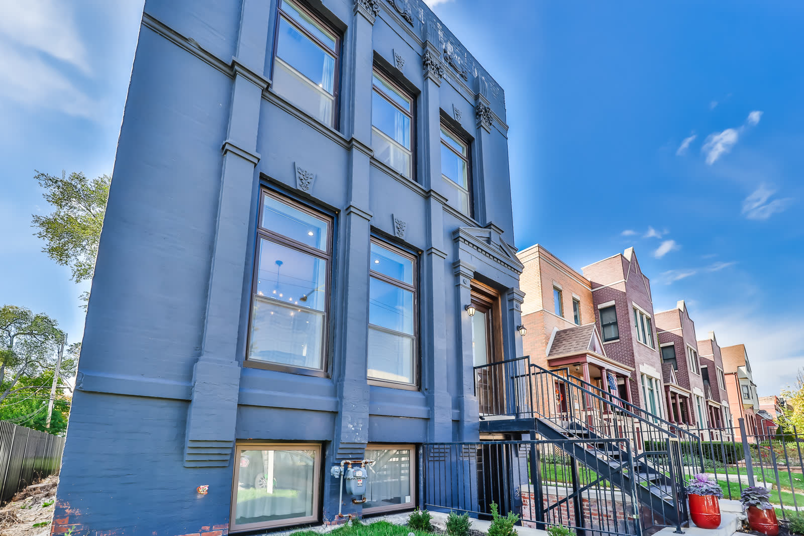 Renovated South Side Chicago home with a welcoming front entry and planters.
